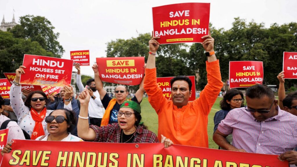 People Hold Signs At A Protest Against Violence Targeting Bangladesh S Minority Hindus After Former.jpeg